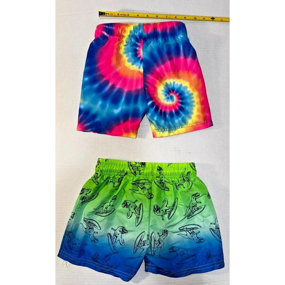 These Hurley toddler boys' swim trunks feature a vibrant spiral tie-dye pattern